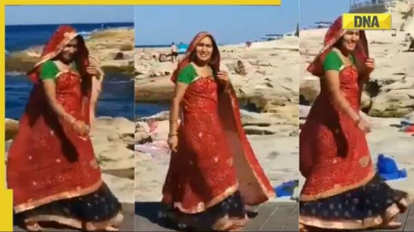 一段走红的视频:一名身穿纱丽的女子和一群身穿比基尼的女子一起走在沙滩上，让网友们印象深刻